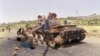 FILE - Eritrean children play on a destroyed Ethiopian army tank, June 7, 1991, near Amara, Eritrea.