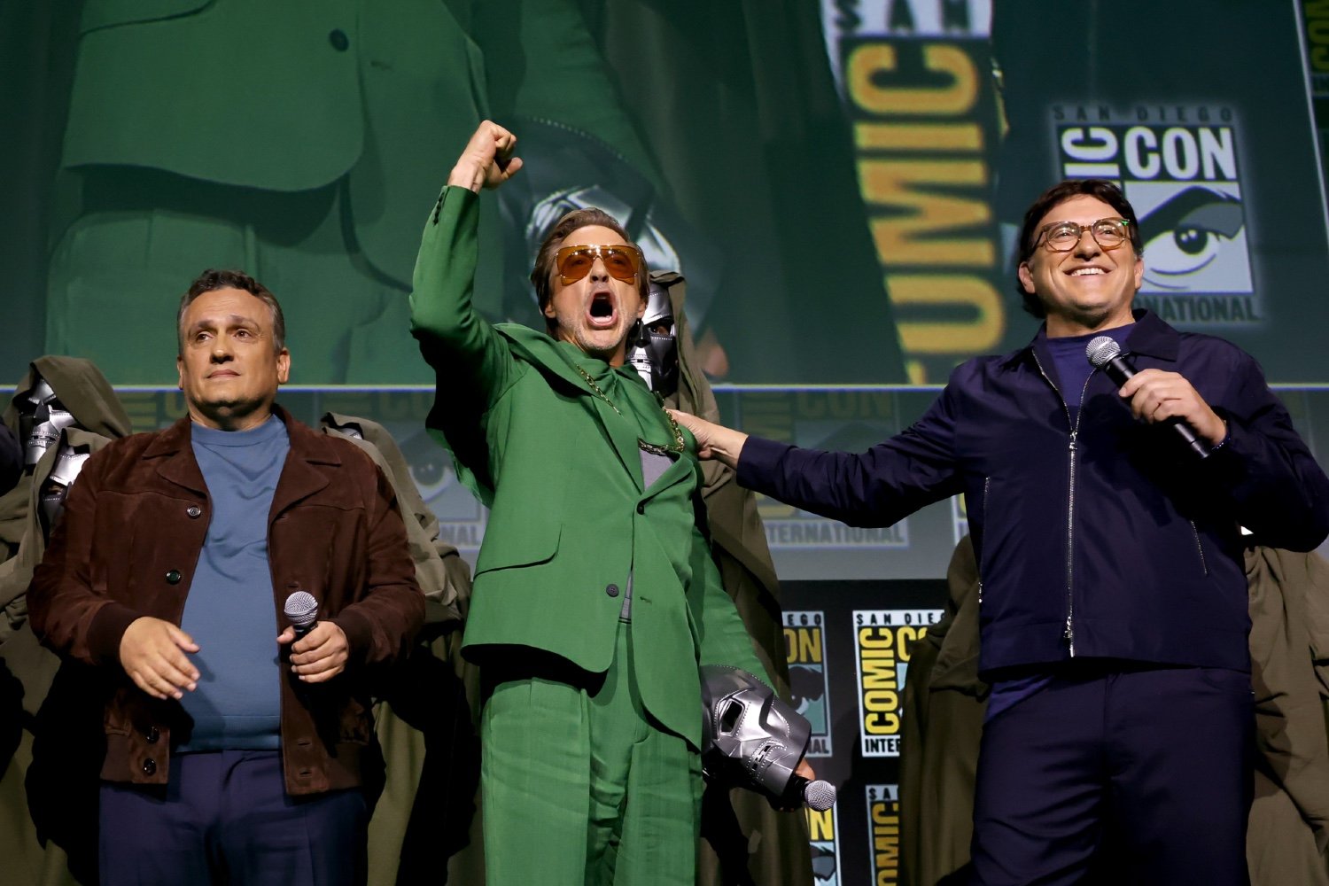 Joe Russo, Robert Downey Jr., and Anthony Russo speak onstage during the Marvel Studios Panel in Hall H at SDCC in San Diego, California on July 27, 2024