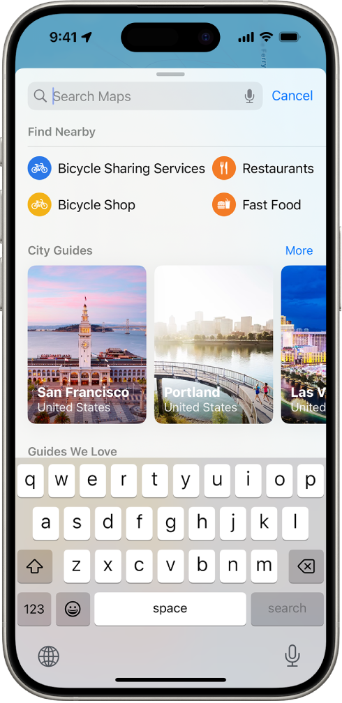 “地图” App 显示搜索栏、附近服务的类型以及城市指南。屏幕底部是 iPhone 屏幕键盘。