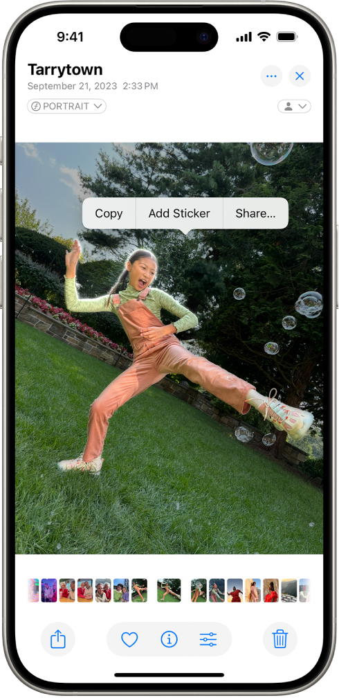 The Photos app is open to a photo of a person. The person is selected, and the option Add Sticker is available in the menu above.