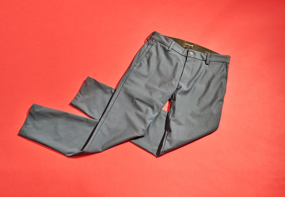 gray pants laid out on a solid red background