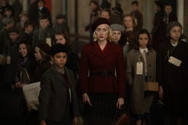 elliott heffernan and saoirse ronan surrounded by a crowd of people in a scene from the movie blitz