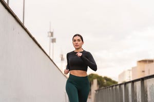 focused woman's running routine for health and wellness