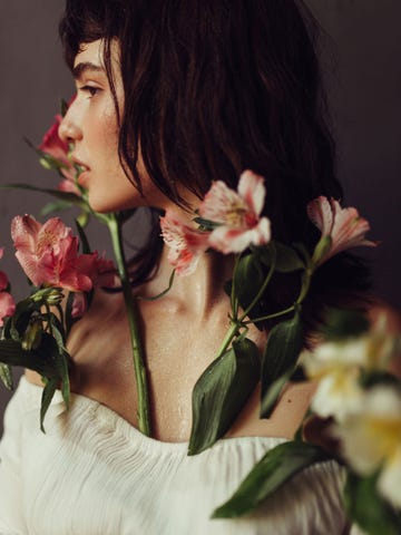 a woman smelling flowers