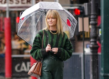 paris, france march 01 jeanette madsen wears a green and black striped wool pullover, green flared leather pants, a brown leather bag, a golden necklace, during paris fashion week womenswear fallwinter 20202021, on march 01, 2020 in paris, france photo by edward berthelotgetty images