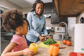 mother and daughter making a salad