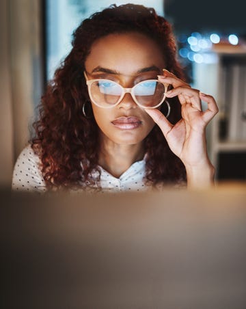 shot of a young businesswoman using a computer during a late night at work in a modern office