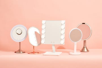 five vanity mirrors with lights on a pink background, good housekeeping's picks for the best vanity mirrors with lights