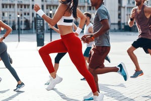 group of people in sports clothing jogging