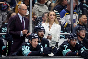 jessica campbell and dan bylsma look on during the first period in the seattle kraken versus st louis blues on october 08, 2024