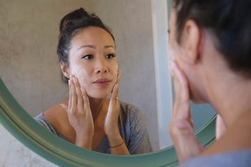 indonesian woman washing her face using beauty cleanser soap