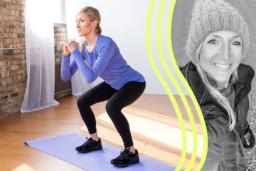 a person is engaged in a squat exercise, positioned on a yoga mat with a wooden floor the setting features large windows allowing natural light to illuminate the space with a brick wall in the background the individual wears a long sleeved blue top and black leggings and appears focused on maintaining proper form during the squat the environment conveys a sense of fitness and wellness