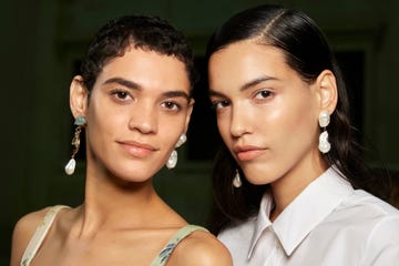 Two individuals wearing statement earrings