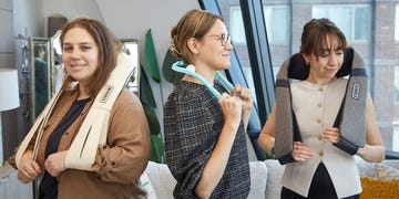 three individuals demonstrating different types of shoulder massagers in a modern setting