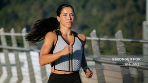 a woman wearing a weighted vest for walking benefits cardiovascular and muscular health by adding resistance and intensity to walking workouts