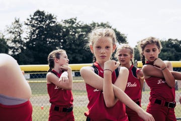 portrait of confident softball player stretching