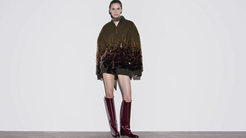 model wearing a stylish oversized sequined jacket and kneehigh boots