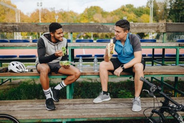 two young male cyclists taking a break of bicycle ride in the city park