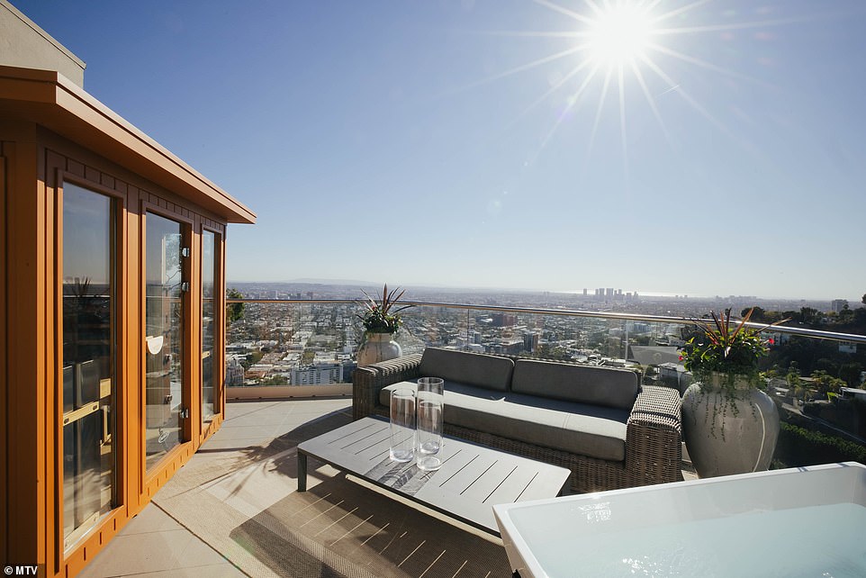 Sun seeker: Another room leads out into a balcony where the singer has placed a sun-facing sauna and seating area