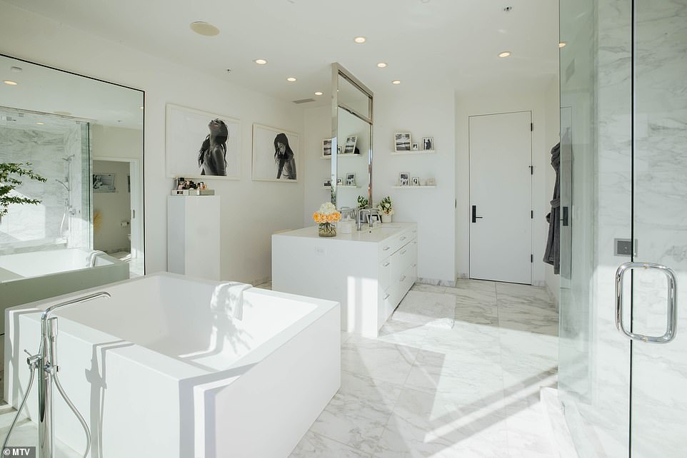 Pamper room: The chic space also boasts while it also has a deep-soaking tub, a steam shower and a double-sided mirror in the vanity area