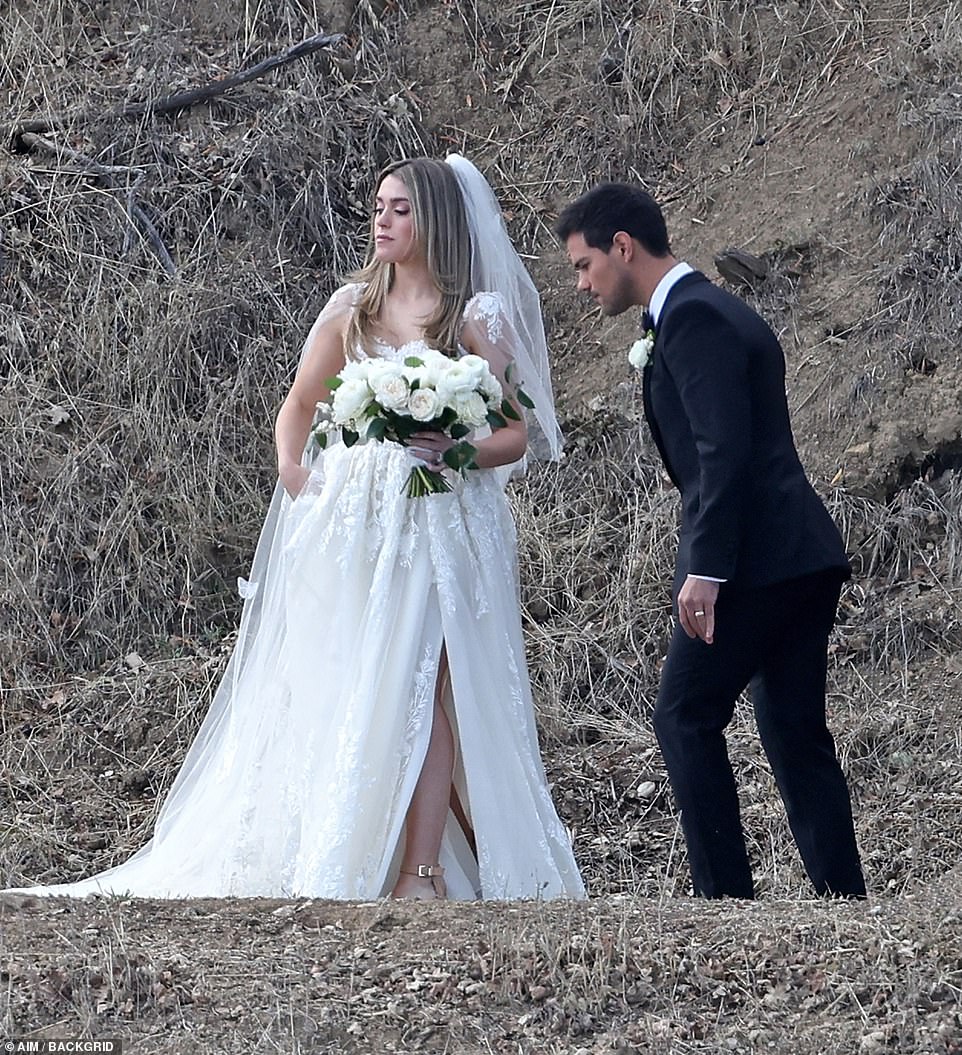 Outstanding: Taylor made a breathtaking bride in her billowing gown and white rose bouquet