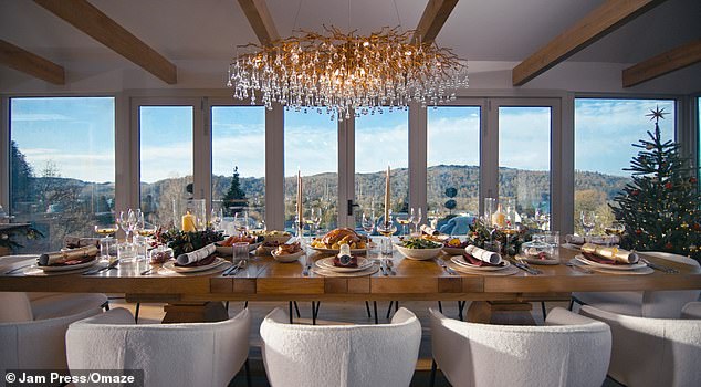 The house's dining room has a stunning view from a wall of windows out onto a terrace and beyond, onto the mountains (pictured)