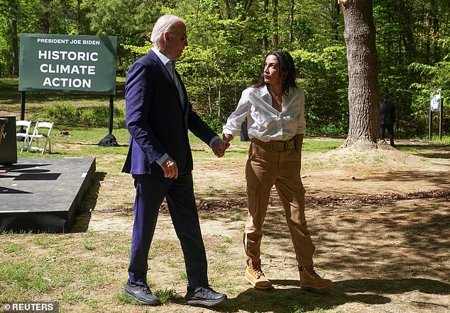 U.S. President Joe Biden and U.S. Representative Alexandria Ocasio-Cortez (D-NY) hold hands at an event to commemorate Earth Day during a visit to Prince William Forest Park in Triangle, Virginia, U.S., April 22, 2024