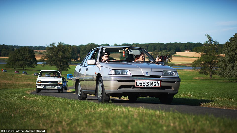 A 1994 Proton 1.5 GL drives up to the entrance of the show, followed closely by a Mk1 Ford Fiesta