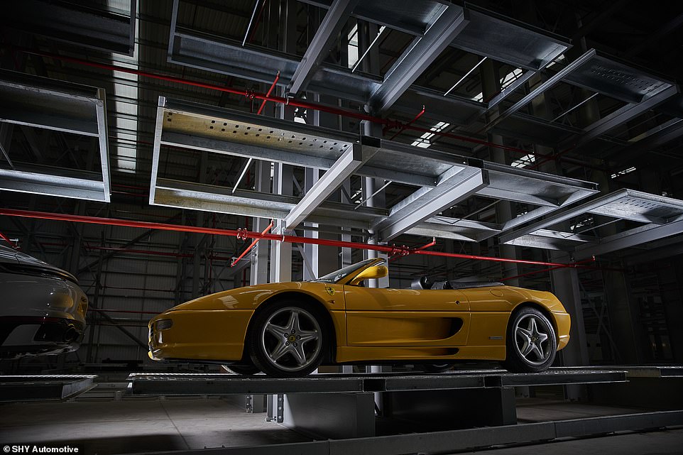 The cars are lifted onto their own dedicated metal 2.2 by 4.8 metre tamper-proof bed which is part of a bespoke racking storage system built from galvanised steel. Pictured: a Ferrari F355 Spider