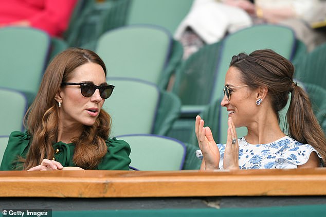 The sisters chatting while watching a tennis match at Wimbledon in 2019