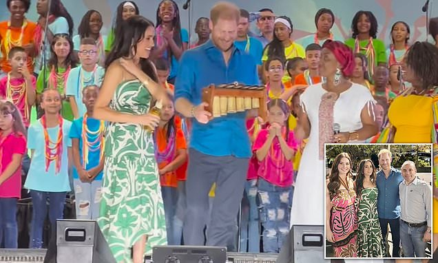 Meghan looks gorgeous in green as Harry is gifted musical instrument during latest stop on