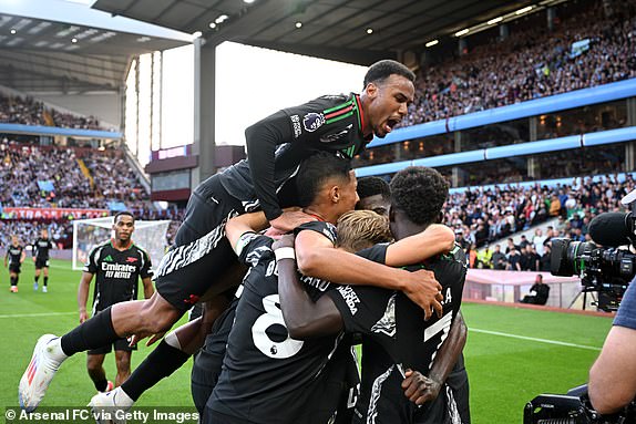 BIRMINGHAM, ENGLAND - AUGUST 24: Thomas Partey of Arsenal celebrates scoring his team's second goal with teammates during the Premier League match between Aston Villa FC and Arsenal FC at Villa Park on August 24, 2024 in Birmingham, England. (Photo by Stuart MacFarlane/Arsenal FC via Getty Images)