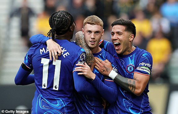 WOLVERHAMPTON, ENGLAND - AUGUST 25: Cole Palmer of Chelsea celebrates scoring his team's second goal with teammates Enzo Fernandez and Noni Madueke during the Premier League match between Wolverhampton Wanderers FC and Chelsea FC at Molineux on August 25, 2024 in Wolverhampton, England. (Photo by David Rogers/Getty Images)