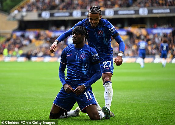 WOLVERHAMPTON, ENGLAND - AUGUST 25: Noni Madueke of Chelsea celebrates scoring his team's fourth goal with teammate Malo Gusto during the Premier League match between Wolverhampton Wanderers FC and Chelsea FC at Molineux on August 25, 2024 in Wolverhampton, England. (Photo by Darren Walsh/Chelsea FC via Getty Images)