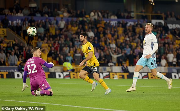 Wolverhampton Wanderers' Goncalo Guedes scores their side's second goal of the game during the Carabao Cup second round match at Molineux Stadium, Wolverhampton. Picture date: Wednesday August 28, 2024. PA Photo. See PA story SOCCER Wolves. Photo credit should read: Gary Oakley/PA Wire.RESTRICTIONS: EDITORIAL USE ONLY No use with unauthorised audio, video, data, fixture lists, club/league logos or "live" services. Online in-match use limited to 120 images, no video emulation. No use in betting, games or single club/league/player publications.