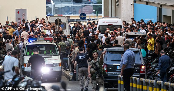 Ambulances are surrounded by people at the entrance of the American University of Beirut Medical Center, on September 17, 2024, after explosions hit locations in several Hezbollah strongholds around Lebanon amid ongoing cross-border tensions between Israel and Hezbollah fighters. Hundreds of people were wounded when Hezbollah members' paging devices exploded simultaneously across Lebanon on September 17, in what a source close to the militant movement said was an "Israeli breach" of its communications. (Photo by Anwar AMRO / AFP) (Photo by ANWAR AMRO/AFP via Getty Images)