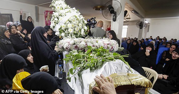 Relatives mourn Fatima Abdallah, a 10-year-old girl killed after hundreds of paging devices exploded in a deadly wave across Lebanon, during her funeral in the village of Saraain in the Bekaa valley on September 18, 2024. Hundreds of pagers used by Hezbollah members exploded across Lebanon Tuesday, killing at least nine people and wounding around 2,800 in blasts the Iran-backed militant group blamed on Israel. (Photo by AFP) (Photo by -/AFP via Getty Images)