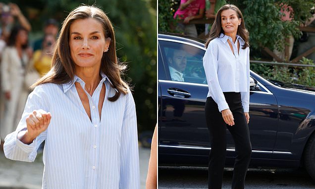 Queen Letizia of Spain opts for trendy shirt with bold cut outs as she opens a school