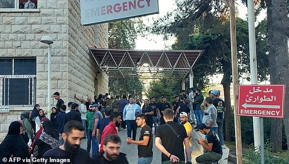 People gather outside a hospital in Baalbek in east Lebanon after communication devices exploded for a second day in Hezbollah strongholds in the country, on September 18, 2024, amid ongoing cross-border tensions between Israel and Hezbollah fighters. Communication devices exploded on July 18 in Hezbollah strongholds in Lebanon, as the Iran-backed group vowed to retaliate against Israel after a deadly wave of pager blasts that has raised fears of an all-out war. (Photo by AFP) (Photo by -/AFP via Getty Images)