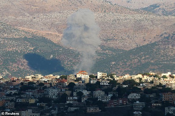 Smoke rises from the southern Lebanese town of Khiam, amid ongoing cross-border hostilities between Hezbollah and Israeli forces, as pictured from Marjayoun, near the border with Israel, September 18, 2024. REUTERS/Karamallah Daher