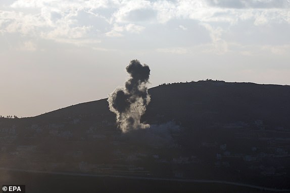 epa11612101 Smoke rises as a result of an Israeli airstrike on the southern Lebanese village of Kfar Kila, as seen from the Upper Galilee in northern Israel, 18 September 2024. The Israeli military stated that several missiles fired from Lebanon crossed into Israeli territory and were intercepted by the Iron Dome air defense system.  EPA/ATEF SAFADI