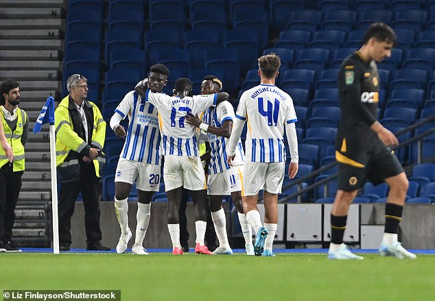 The Brighton players celebrate with Carlos Adingra (2nd right) after he doubled the lead