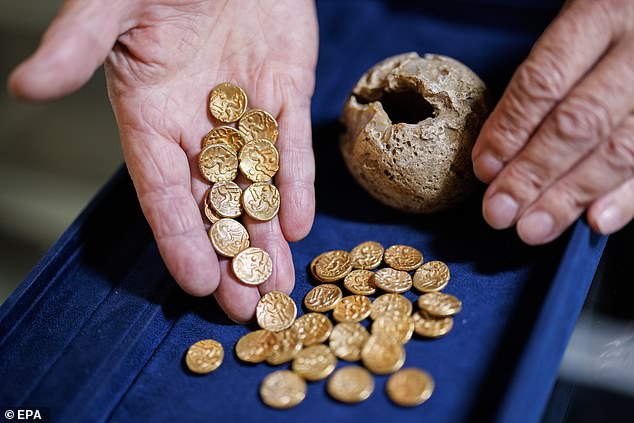 The coins were concealed inside a flint nodule which had broken open when the field was ploughed, scattering its contents