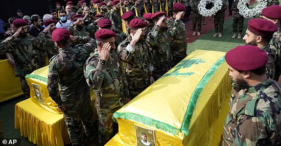 Hezbollah members attend the funeral of two of their comrades who were killed on Wednesday when a handheld device exploded in the southern suburbs of Beirut, Thursday, Sept. 19, 2024. (AP Photo/Hussein Malla)