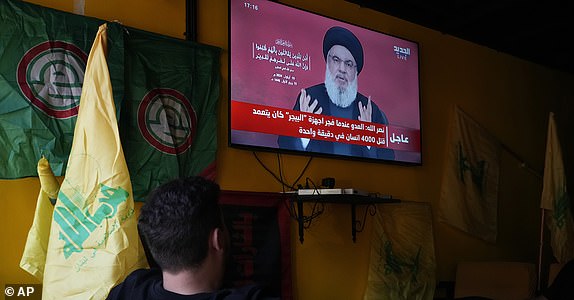 People watch the speech of Hezbollah leader Hassan Nasrallah as they sit in a cafe in the southern suburbs of Beirut, Thursday, Sept. 19, 2024. (AP Photo/Hassan Ammar)