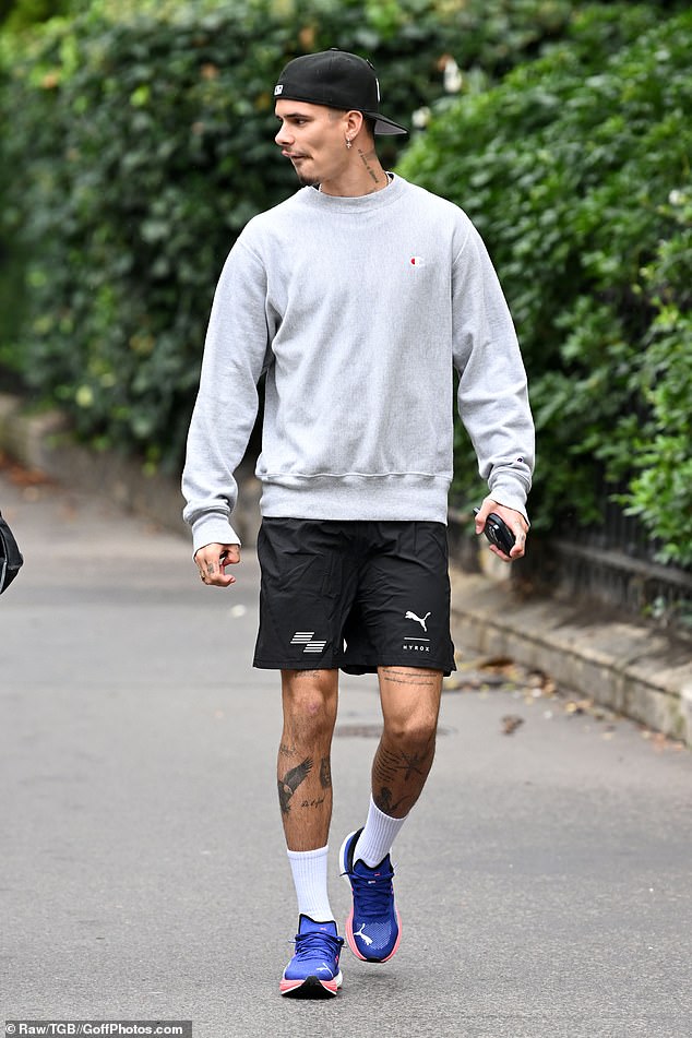 Romeo looked effortlessly cool as he teamed the grey sweatshirt with a pair of black running shorts