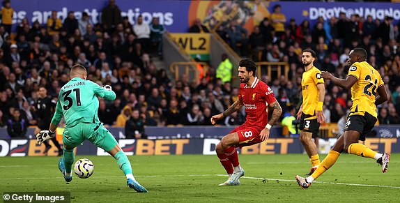 WOLVERHAMPTON, ENGLAND - SEPTEMBER 28: Sam Johnstone of Wolverhampton Wanderers saves the shot of Dominik Szoboszlai of Liverpool during the Premier League match between Wolverhampton Wanderers FC and Liverpool FC at Molineux on September 28, 2024 in Wolverhampton, England. (Photo by Michael Steele/Getty Images)