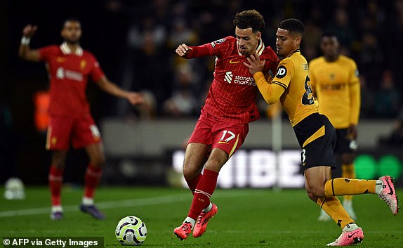 Wolverhampton Wanderers' Brazilian midfielder #08 Joao Gomes (R) tussles with Liverpool's English midfielder #17 Curtis Jones during the English Premier League football match between Wolverhampton Wanderers and Liverpool at the Molineux stadium in Wolverhampton, central England on September 28, 2024. (Photo by Paul ELLIS / AFP) / RESTRICTED TO EDITORIAL USE. No use with unauthorized audio, video, data, fixture lists, club/league logos or 'live' services. Online in-match use limited to 120 images. An additional 40 images may be used in extra time. No video emulation. Social media in-match use limited to 120 images. An additional 40 images may be used in extra time. No use in betting publications, games or single club/league/player publications. /  (Photo by PAUL ELLIS/AFP via Getty Images)