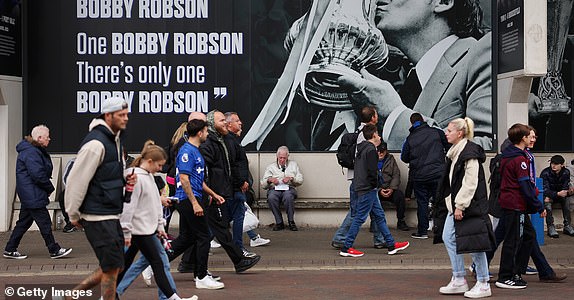 IPSWICH, ENGLAND - SEPTEMBER 29: Fans of Ipswich Town make their way to the stadium, past a mural dedicated to Sir Bobby Robson prior to the Premier League match between Ipswich Town FC and Aston Villa FC at Portman Road on September 29, 2024 in Ipswich, England. (Photo by Julian Finney/Getty Images)