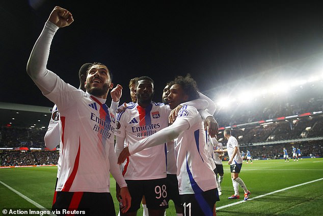 Malick Fofana celebrates with his Lyon team-mates after scoring his second goal of the night.